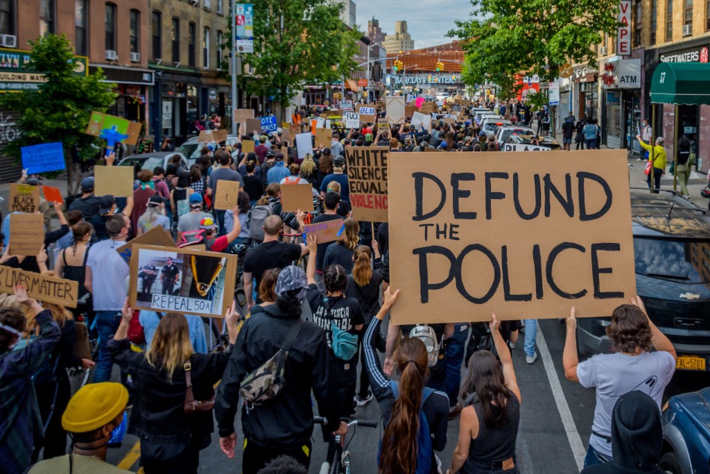 A participant holding a Defund The Police sign at the protest. Thousands of protesters filled the streets of Brooklyn on June 2, 2020, in a massive march to demand justice for George Floyd, killed by Officer Derek Chauvin and to make a loud call for the defunding of the police force. (Photo Erik McGregor/LightRocket/Getty Images)